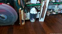 Photo showing dark painted pot filled with white snowballs next to tall wooden snowman statuette with star cutout