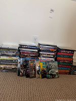 Wide view of multiple DVD stacks showing Friends box sets and other movie DVDs