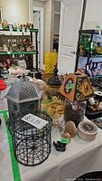 View of all items on table including amber jar, candleholder, jars, candles, coasters, and small decor items