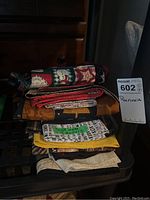 Stack of folded handmade runners of varying colors and patterns