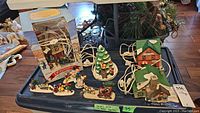 Overview of all village houses, Lomax figures, and ceramic tree arranged on table