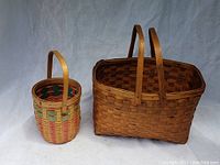 Photo showing both baskets side by side on a plain background, displaying size and color differences.