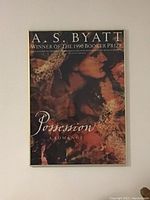 Framed art print showing the full front view of the print including the title and author text with a dark, textured image and floral patterns.