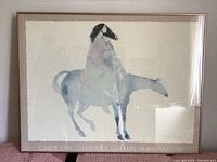 Front view of framed art print showing a woman on a horse with signature and gallery text.