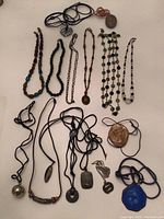 Overview of all necklaces and pendants laid out on white background