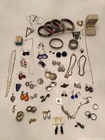 Full lot overview showing all earrings, bracelets, rings, necklaces and boxed pearl earrings