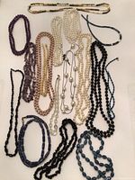 Full lot overview of various necklaces showing varying colors, bead shapes, and sizes.