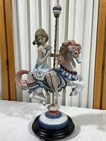 Front view of entire figurine on wood base