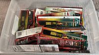 Container with multiple long handled lighters in original packaging viewed from above