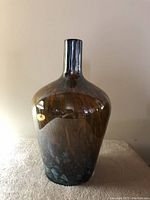 Front view of glass vase showing color gradient from brown to bluish-black with glossy finish.