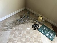 Full lot overview with all jars, rings, sealers, and ceramic jar arranged on carpet.