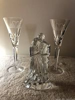 Waterford crystal bride and groom figurine with two matching champagne glasses showing etched heart and leaf design.