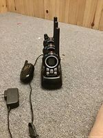 Four walkie talkies shown, one Cobra with charger and three Motorola units.