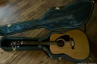 Interior view of open hard shell case with Yamaha acoustic guitar inside