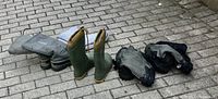 Photo showing all three pairs of boots arranged on paved surface: Kamik boots, Glacier Sorel Raufman boots, and Neos Overshoe boots visually confirmed.