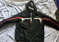 Front view of the Nike men's winter coat in black with red and white accents, zipper and hood visible.