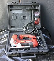Open black plastic carrying case showing the Craftsman jigsaw, electrical cord, and red safety glasses secured inside.