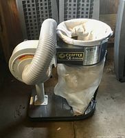 Sawdust collector showing blower unit, drum, filter bag, plastic collection bag and flexible hose