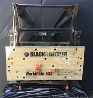 Image showing front view of Black & Decker Workmate 425 workbench with wooden top and metal legs.