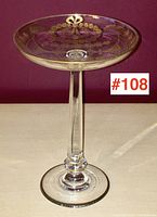 Side view showing the clear glass tazza pedestal with hand-cut and gilded decoration.