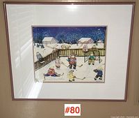 Full view of framed winter hockey scene print on wall