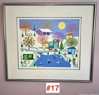Frontal view of the framed colorful folk art winter scene painting signed Militao, showing the entire composition with ice skating children and houses.
