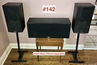 Full view of left and right Klipsch speakers on stands and center speaker