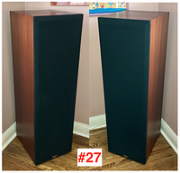 Pair of speakers front view with black fabric grills attached