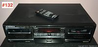 Front view of Pioneer CT-07D Elite stereo double cassette deck with remote control atop