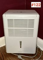 Front view showing white housing, horizontal air vents, water level sight glass and power cord at base