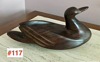 Rosewood carved bird sculpture showing side profile and detailed wing feathers.