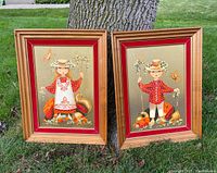 Front view of the two framed prints standing against a tree on grass, showing the girl and boy in farm/harvest themed artwork with velvet and wood frames.