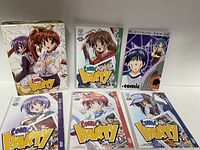Photo showing the front of the box set and six DVD cases with distinct illustrated covers of comic party characters.
