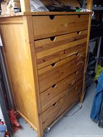 Front view of a solid pine wood 6-drawer chest showing natural wood grain and drawer handles, with visible minor scratches on surface.