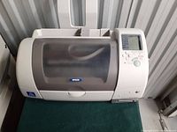 Closed top view of Epson Stylus Photo 785EPX printer showing the see-through cover and control panel on the right.