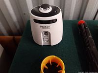 Photo of iRobot Roomba virtual wall barrier device shown with black and white casing and control dial.