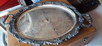 Full view of the rectangular vintage silver-plated serving tray showing ornate raised edge and heavy handles.
