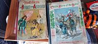 Photo of two religious story books: 'Holidays at Home and Abroad' and 'Child's Story of the Bible' showing colorful illustrated covers