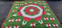 Top view of the large colorful sewn bedspread laid flat showing full pattern and colors.