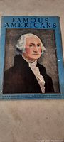 Blue cover page of vintage publication titled 'Famous Americans' featuring a color portrait of George Washington.