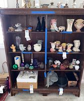 Front view of the vintage oak four-shelf unit showing the shape, shelves, and wood detail.