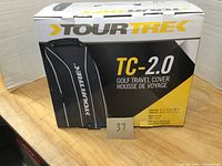 Box packaging showing the Tour Trek TC-2.0 golf travel cover and product branding.