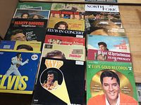 Top view of LP records showing Elvis Presley and other artists' album covers stacked in a box
