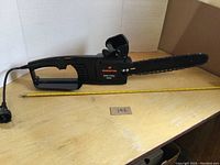 Full side view of the Remington electric chainsaw showing its length and overall design.