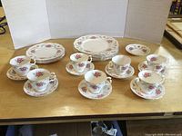 Photo showing full set of Royal Albert Tranquility dinnerware with cups, saucers, and plates arranged on table