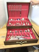 Two-tier wooden flatware chest open, showing top silverplate drawer and bottom sterling drawer