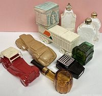 Ten vintage Avon cologne bottles of varied shapes including novelty cars, truck, pack of cigarettes, cigar, and ceramic bottles with gold caps.