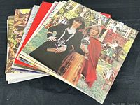 Stack of 12+ classic rock vinyl records with colorful front album covers showing various artists.