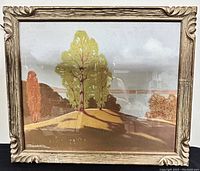 Full view of framed landscape pastel painting showing trees on hill by water, signed lower left, frame with decorative corners and visible wear.