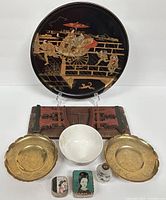 Full lot showing the lacquered serving tray, brass plates, porcelain bowl, enamel pill boxes, small figurine, and wooden stand.